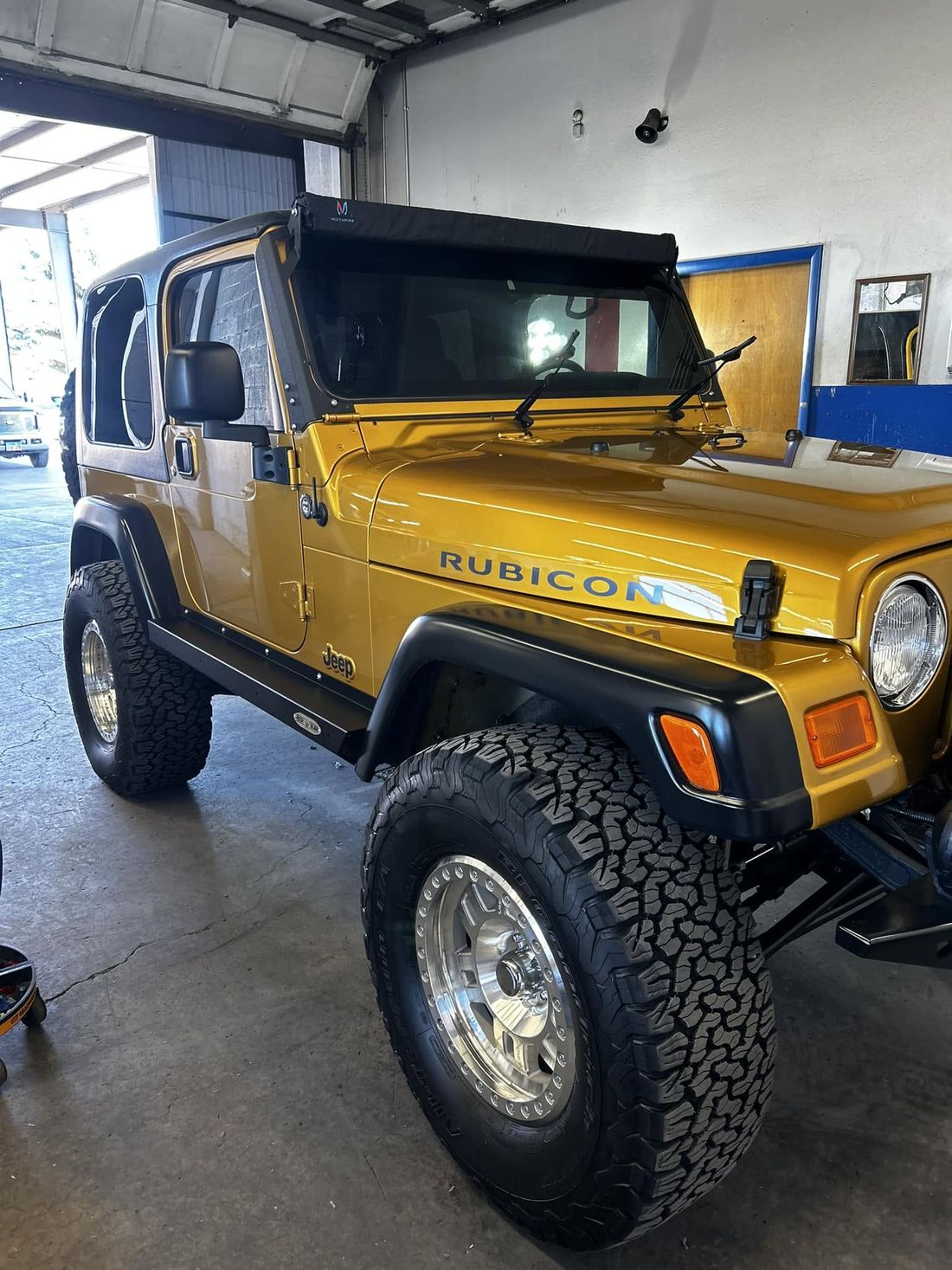 Gold Jeep Wrangler Rubicon after a full detail at Red Dirt Autovisions in Richfield, Utah